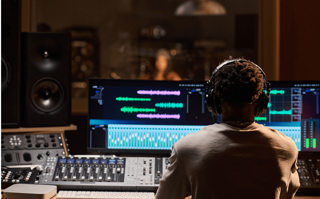 Person mixing audio in recording studio.